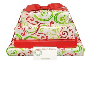 Three stacked gift boxes wrapped in white paper with red and green swirls, topped with a red bow, and a “Season’s Greetings” card in front.