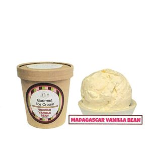 A container of Madagascar Vanilla Bean sits beside a scoop of the ice cream in a white bowl.